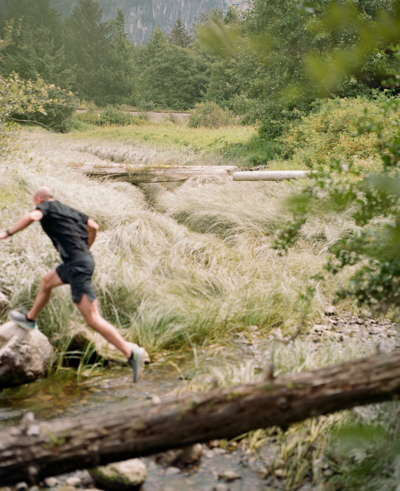 A man exercising outside in greenery